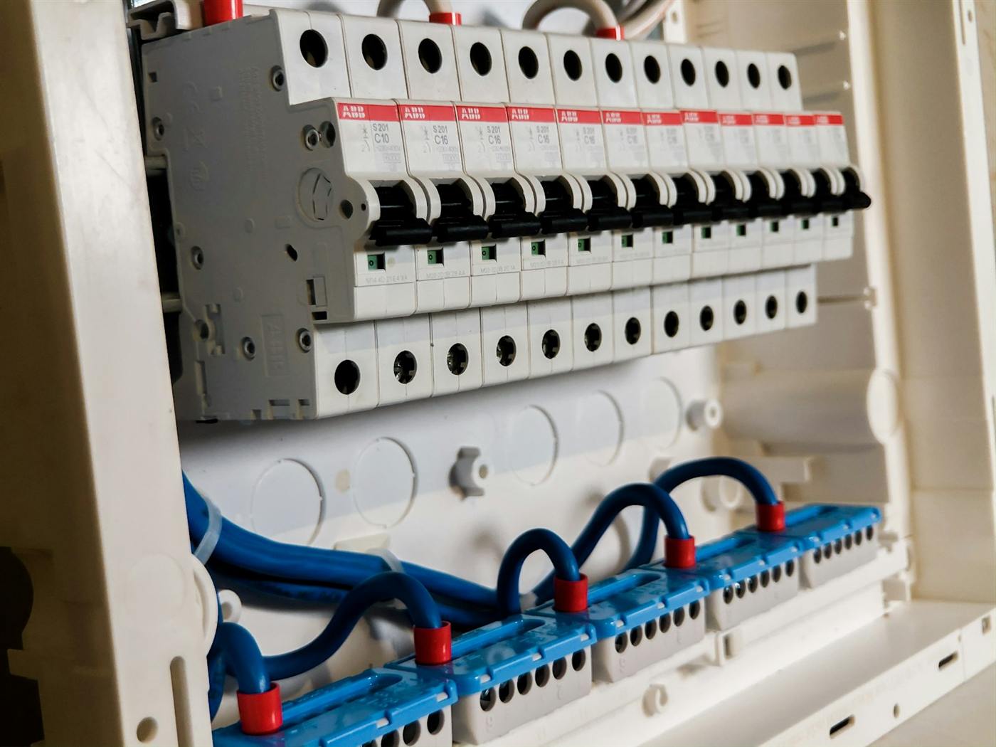Close view of circuit breakers wired inside a distribution board