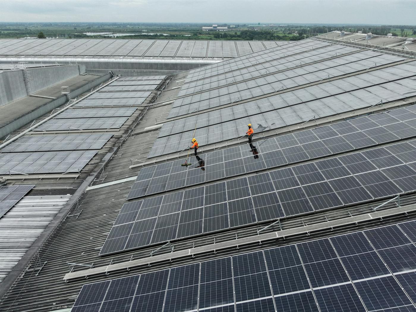 Aerial view of a large industrial roof covered with solar modules